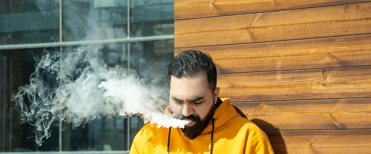 man enjoys his vaping while work break