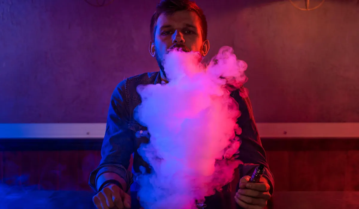 man vaping disposable vape with fully charged battery