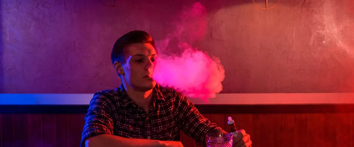 man vapes in a vape bar before the disposable vape expire