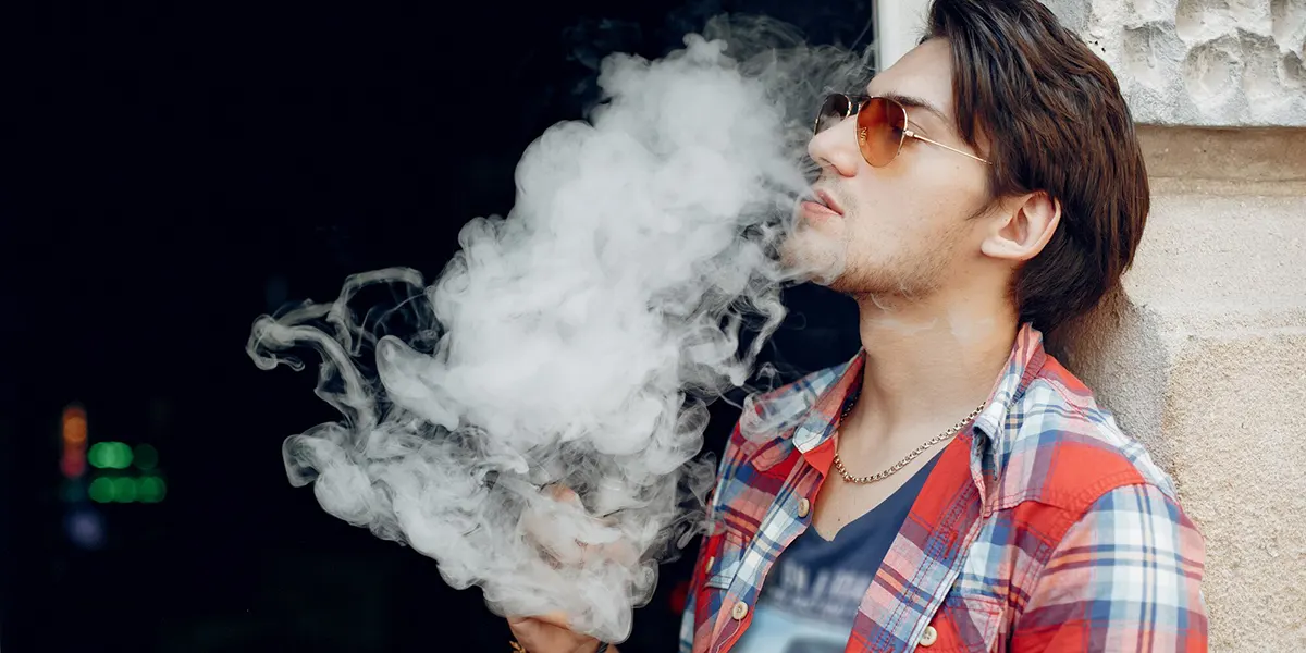 stylish man enjoys his vapor using his favorite disposable vape