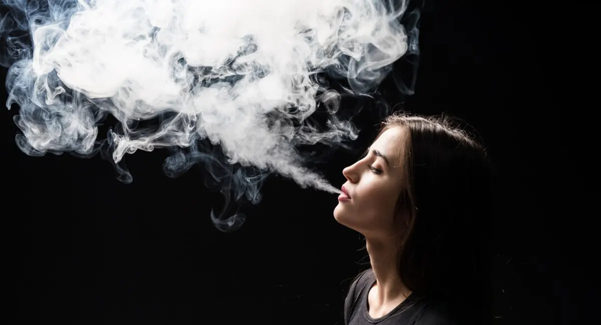 woman vaping e cigarette with cool vapor puffs