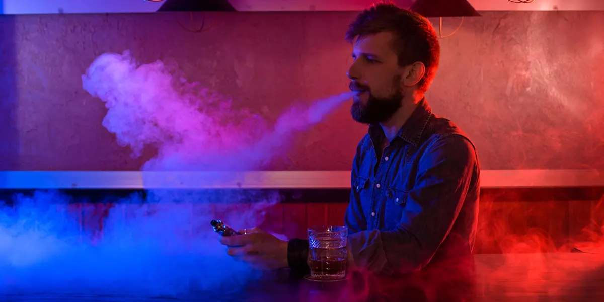 man is vaping disposable vape before his vape dies
