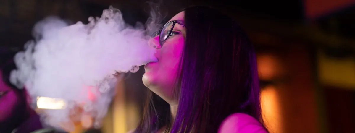 woman relaxing by vaping from active disposable vape