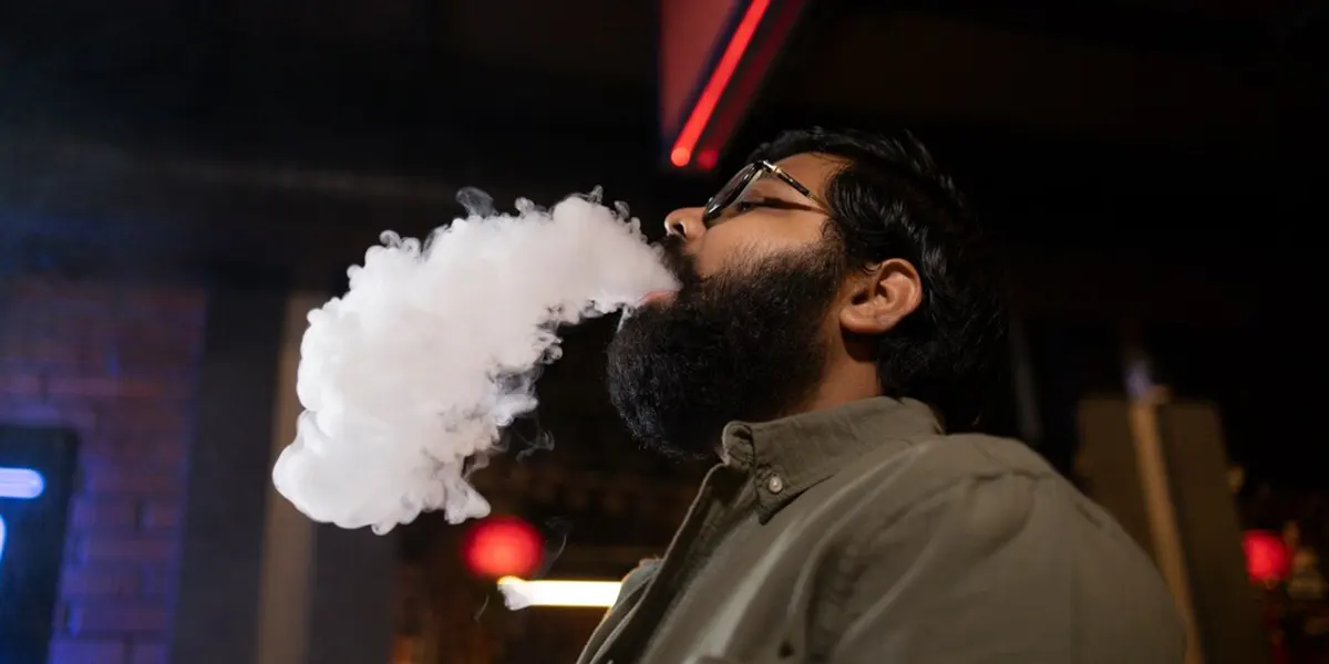 man relaxing by vaping from disposable vape